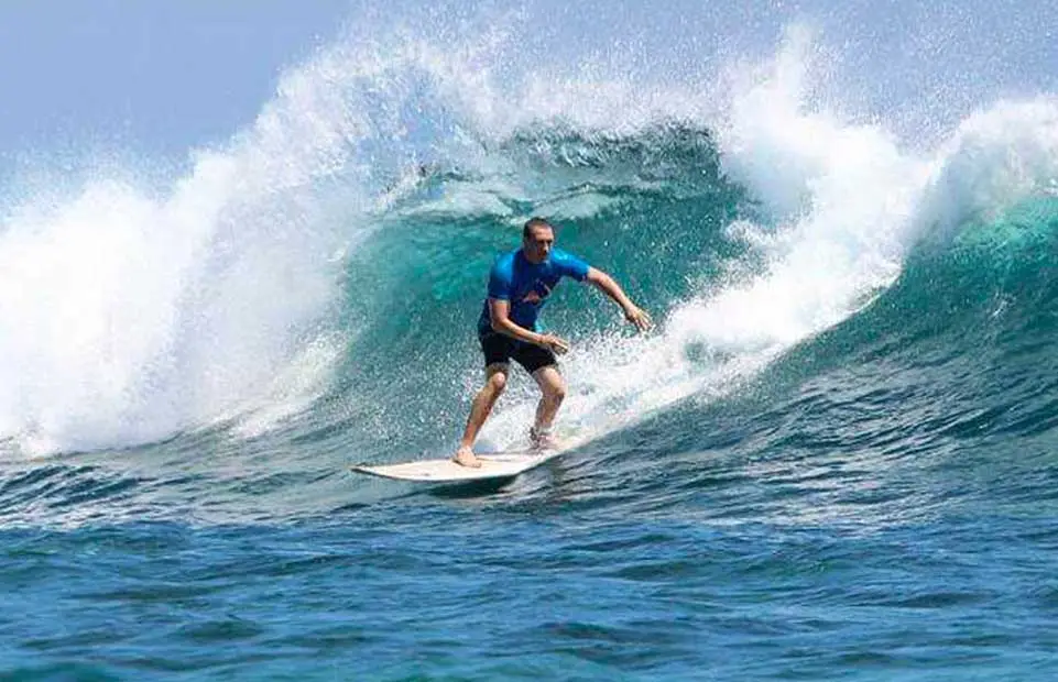 Member of the surf club on a beautiful green wave