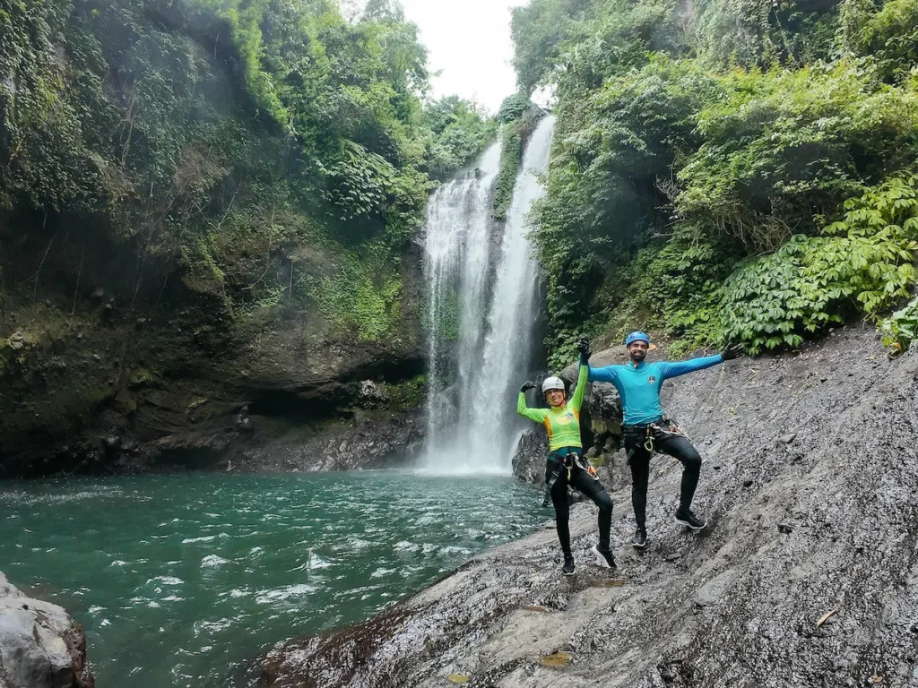 Abseiling down Aling-Aling waterfall during a canyoning adventure in Bali