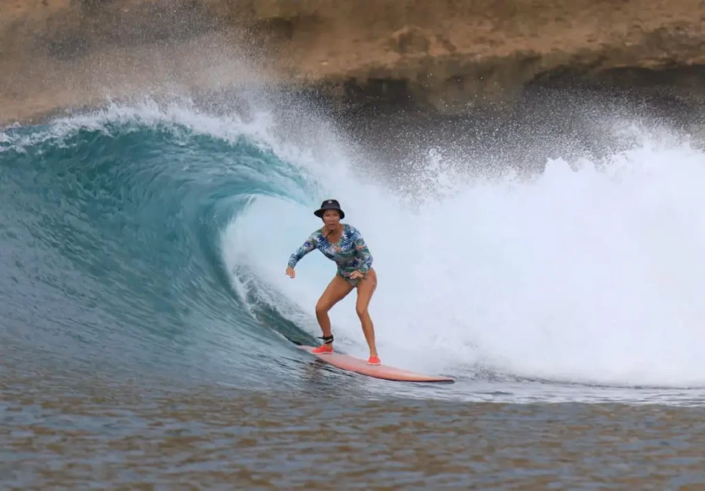 Femmesurfant sur une tres belle vague, photo prise de coté